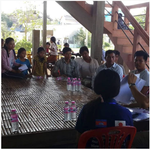 Family community meeting under stilt house